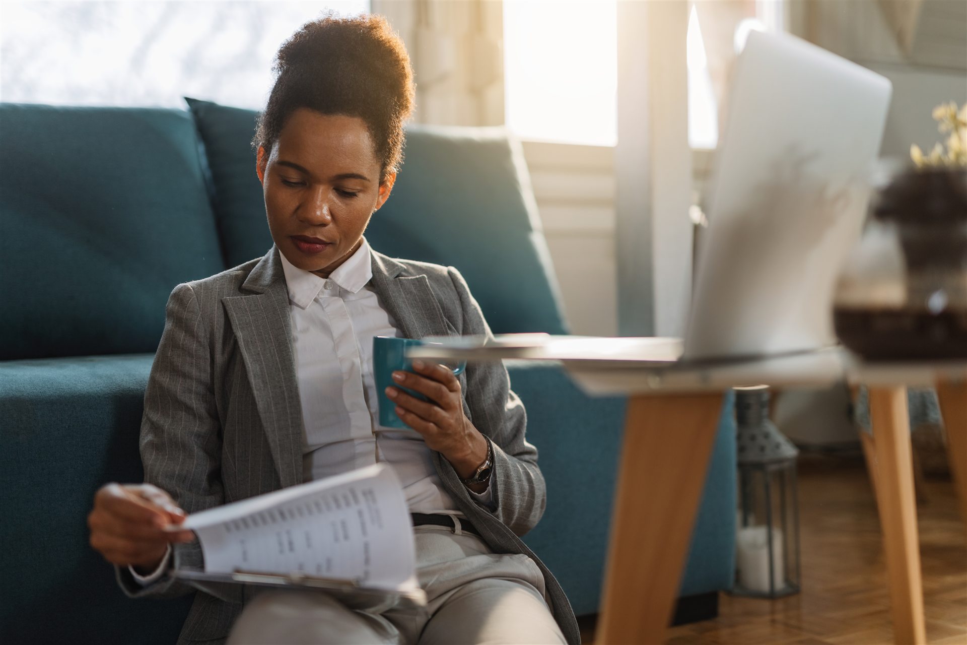 Entrepreneur reviewing business reports from home
